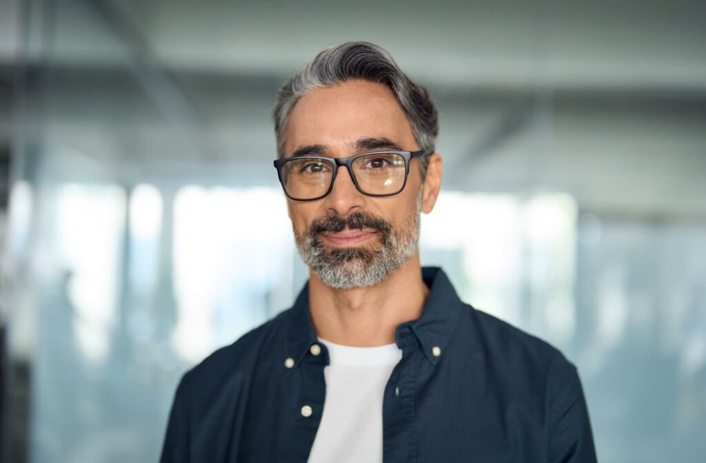 A happy-looking mature man wears his progressive lenses.