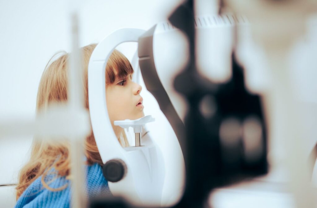 Young girl undergoing an eye exam to monitor myopia progression in an optometry clinic.