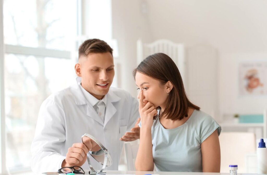 An optometrist teaches a patient how to carefully insert and remove contact lenses.