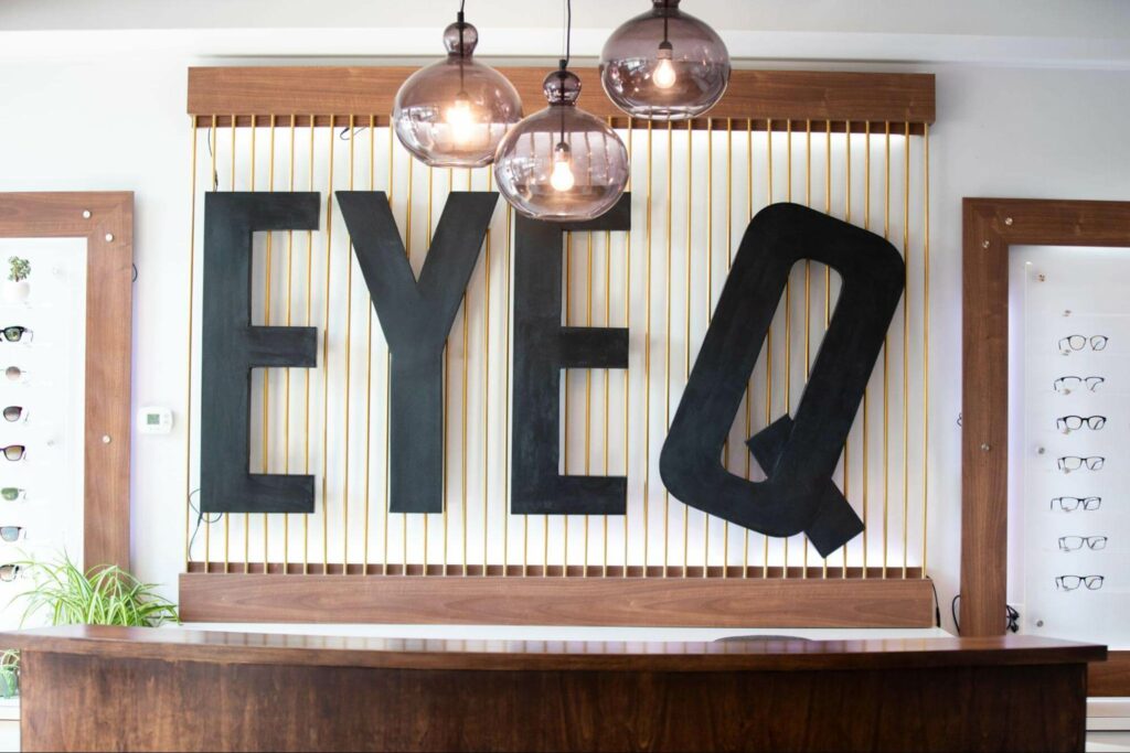Eye Q Optometry signage hang on the call in the middle of the clinic.